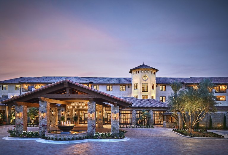 Evening view of the Inn at the Mission San Juan Capistrano, highlighting the stonework and architectural details.
